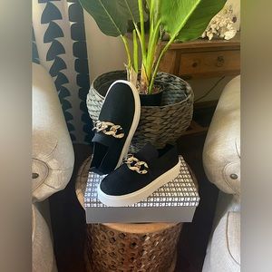 Brand new, never worn New Bella chic slide on sneakers with silver chain design.